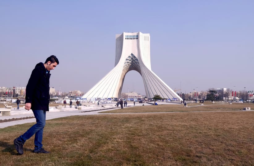 A man walks past Azadi Tower (Liberty Tower) in Azadi Square in Tehran, Iran, January 17, 2016. (photo credit: RAHEB HOMAVANDI/TIMA VIA REUTERS)