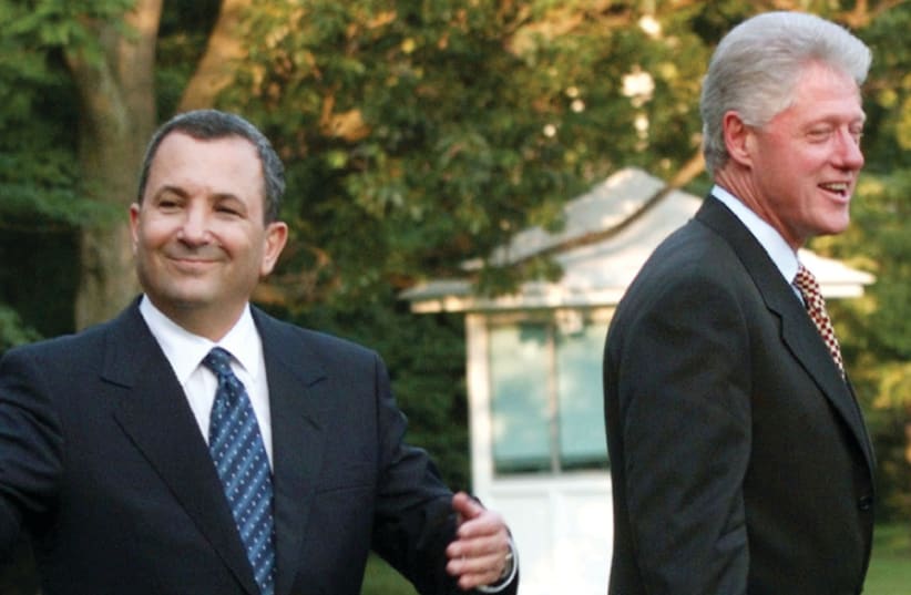 THEN-PRIME MINISTER Ehud Barak gestures as he and US president Bill Clinton depart the White House en route to Camp David in 1999 (photo credit: MARK WILSON/REUTERS)