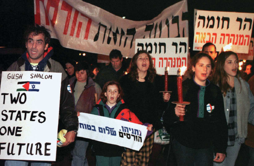 HUNDREDS OF Israeli peace activists demonstrate in 1997 against the decision by the government to build a Jewish neighborhood in east Jerusalem.  (photo credit: RULA HALAWANI/REUTERS)