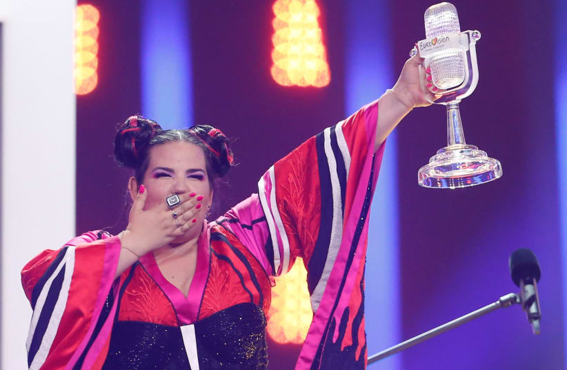 Israel's Netta reacts as she wins the Grand Final of Eurovision Song Contest 2018 at the Altice Arena hall in Lisbon, Portugal, May 12, 2018 (photo credit: REUTERS/PEDRO NUNES)