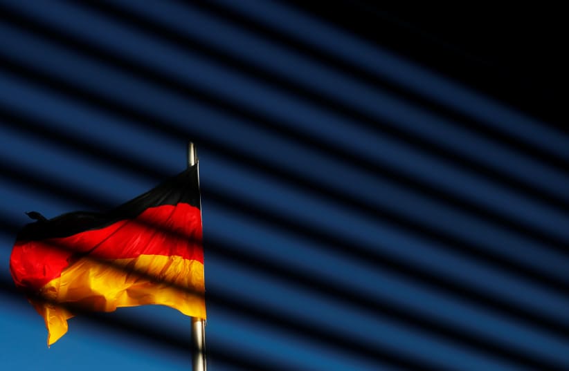 The German flag is pictured at the Reichstag building in Berlin, Germany, November 7, 2017 (photo credit: REUTERS/HANNIBAL HANSCHKE)