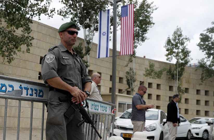 Israeli security forces stand guard outside the US consulate in Jerusalem adjacent to the new US embassy, on May 13, 2018 (photo credit: AHMAD GHARABLI / AFP)