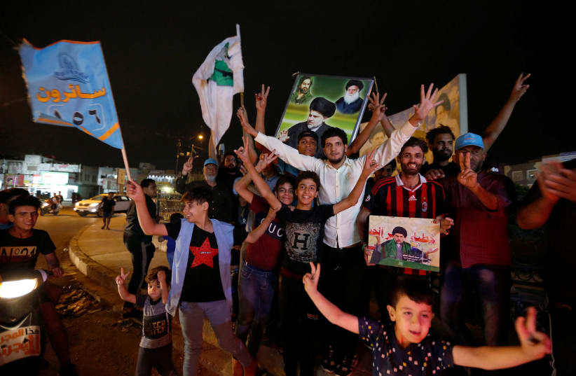 Iraqi supporters of Sairun list celebrate after the closing of ballot boxes during the parliamentary election in Sadr city district of Baghdad, Iraq May 12, 2018 (photo credit: AKO RASHEED / REUTERS)