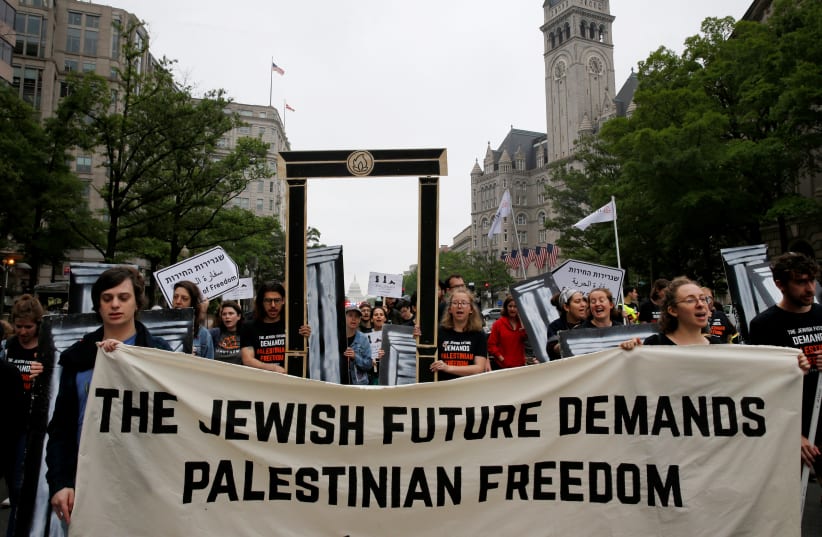 People organized by IfNotNow protest outside of Trump International Hotel against the new U.S. Embassy opening in Jerusalem in Washington, US, May 14, 2018 (photo credit: REUTERS/LEAH MILLIS)