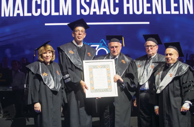 Malcolm Hoenlein (center) receives his honorary doctorate from Bar-Ilan University  flanked by (from left) Gail Propp, Prof. Arie Zaban, president of BIU, Michael Jesselson s and Jewish Agency Chairman Natan Sharansky (photo credit: CHEN DAMARI)