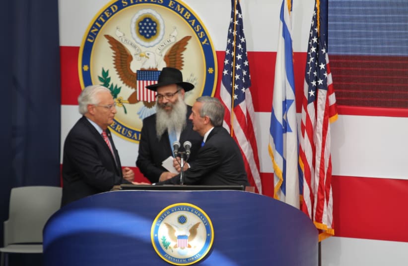 Pastor Robert Jeffress and Rabbi Rabbi Zalman Wolowik share the stage with U.S. Ambassador David Friedman at the openening ceremony for the U.S. embassy in Jerusalem (photo credit: HILLEL MEIR/TPS)