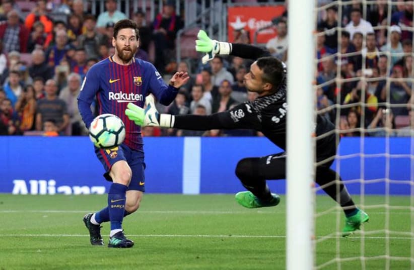 Argentine forward Lionel Messi (L) scores during play for club team F.C. Barcelona, May 9, 2018. (photo credit: ALBERT GEA/ REUTERS)