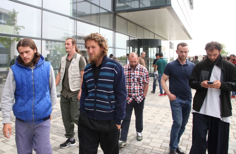 Several of the Kosovar men convicted of plotting to attack the Israeli national soccer team walk in front of a court after their sentencing (photo credit: HAZIR REKA/ REUTERS)