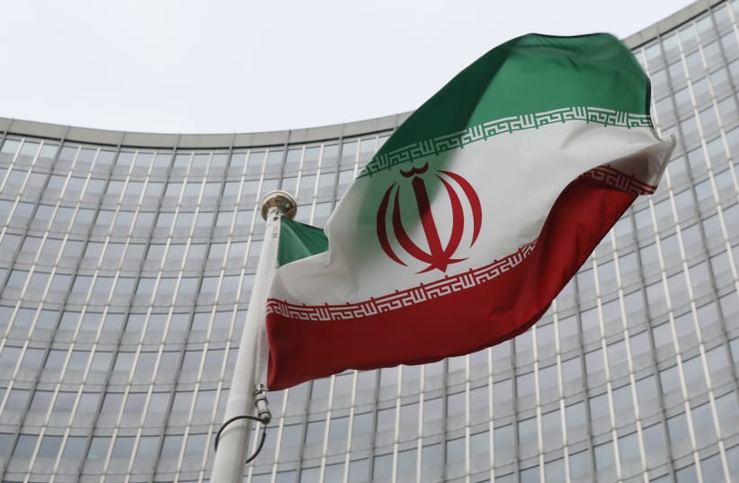 An Iranian flag flutters in front of the International Atomic Energy Agency (IAEA) headquarters in Vienna, Austria, January 15, 2016 (photo credit: REUTERS)