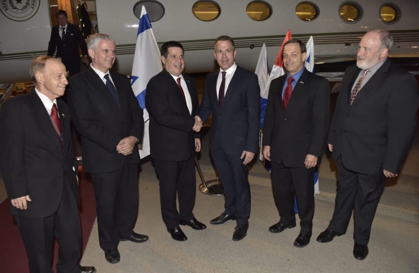 Public Security Minister Gilad Erdan greets Paraguayan President Horacio Cartes Sunday night upon his arrival to Israel. (photo credit: COURTESY FOREIGN MINISTRY)