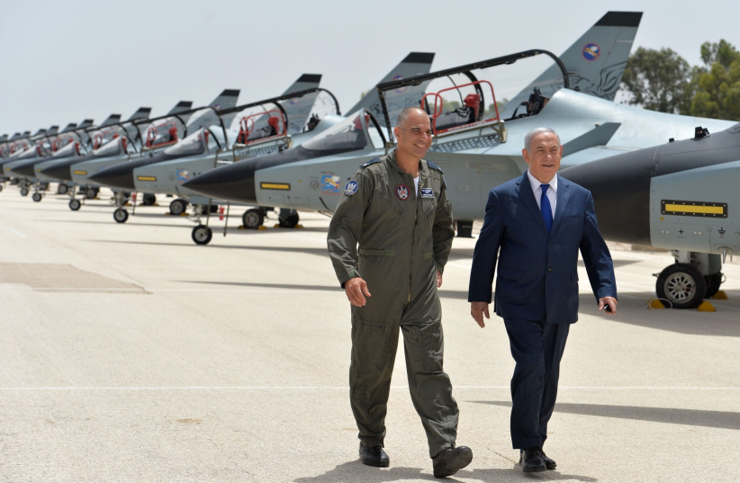 Prime Minister Benjamin Netanyahu and IAF Brigadier General Peleg Niego at Tel Nof Airbase in Rehovot, May 23, 2018 (photo credit: PMO)