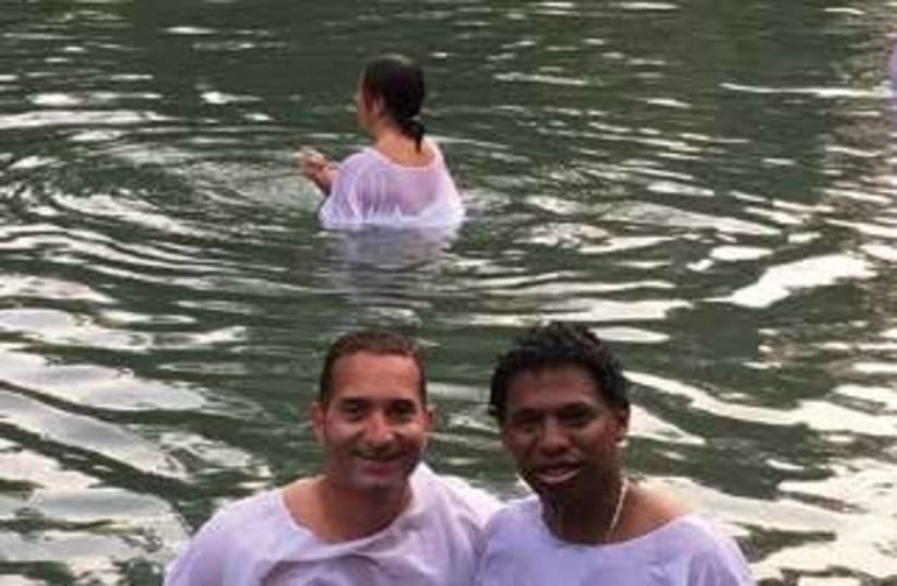  Heroes to Heroes veterans Harrison Manyoma (right) and Omar Jana seen after getting baptized in the Jordan River (photo credit: HEROES TO HEROES)