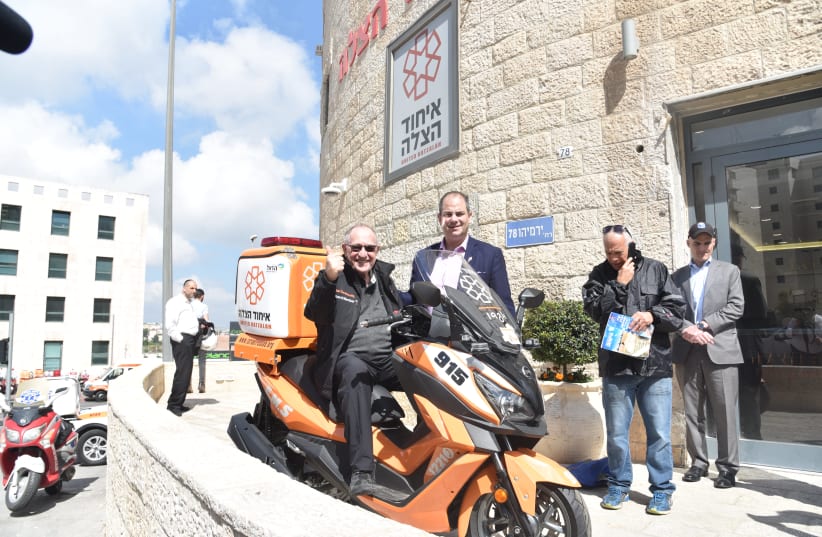 Alan Dershowitz sits on an Ambucycle with United Hatzala founder Eli Beer in Jerusalem (photo credit: Courtesy)