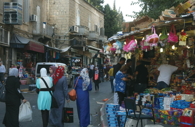 JERUSALEM RESIDENTS walk near Damascus Gate. (photo credit: MARC ISRAEL SELLEM/THE JERUSALEM POST)