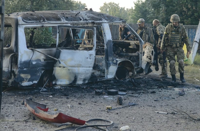 A VAN destroyed during fighting in eastern Ukraine’s Donbas conflict which is now in its fourth year. (photo credit: REUTERS)
