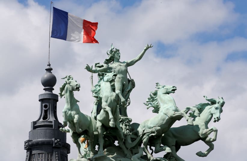The French flag flies above the Grand Palais in Paris, France, June 24, 2017. (photo credit: REUTERS/JEAN-PAUL PELISSIER)