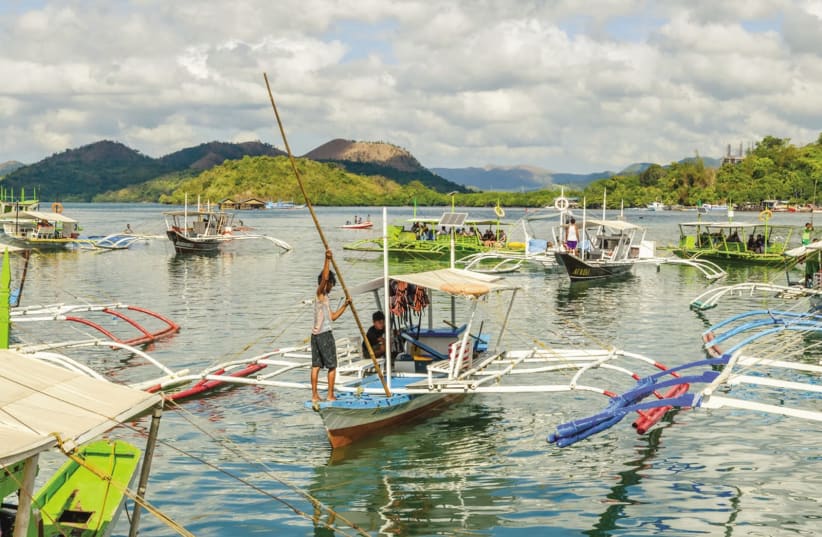 Boats at Coron harbor are for hire to get to various sites on Coron Island, May 27, 2018. (photo credit: HILLARY ZETLER)
