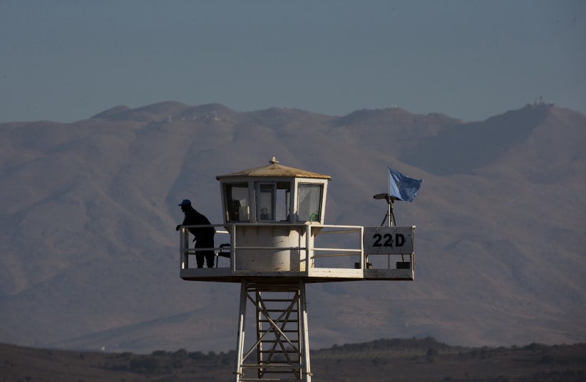 A United Nations peacekeeping soldier stands on an observation tower near the Quneitra border crossing between Israel and Syria (photo credit: REUTERS/Ronen Zvulun)