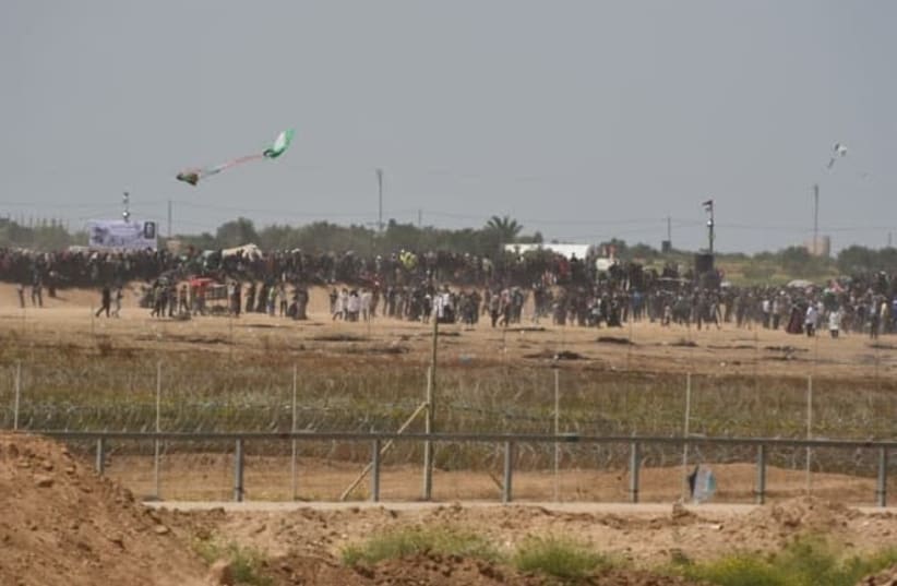Gazan demonstrators launch a kite with a Molotov cocktail attached into Israeli territory. It lands within Gaza's borders (photo credit: IDF SPOKESPERSON'S UNIT)