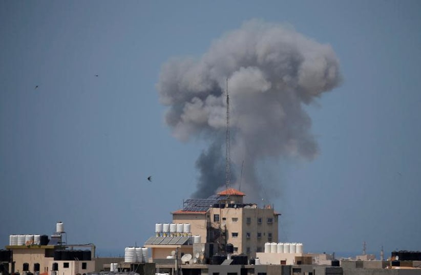 Smoke rises following an Israeli air strike in Gaza May 29, 2018. (photo credit: SUHAIB SALEM / REUTERS)