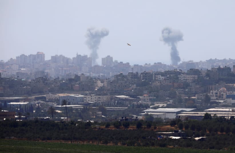 Smoke rises following an Israeli air strike in the Gaza Strip, as seen from the Israeli side of the border between Israel and Gaza, May 29, 2018 (photo credit: AMIR COHEN/REUTERS)