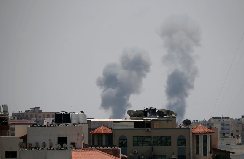 Smoke rises following an Israeli air strike in Gaza May 29, 2018 (photo credit: SUHAIB SALEM / REUTERS)