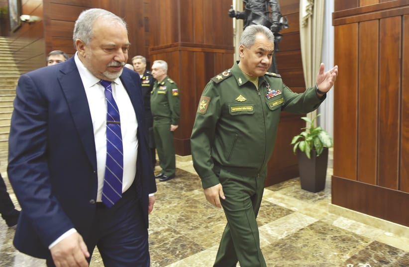 DEFENSE MINISTER Avigdor Liberman and his Russian counterpart, Sergei Shoigu, walk to their meeting in Moscow, May 31, 2018. (photo credit: ARIEL HERMONI / DEFENSE MINISTRY)