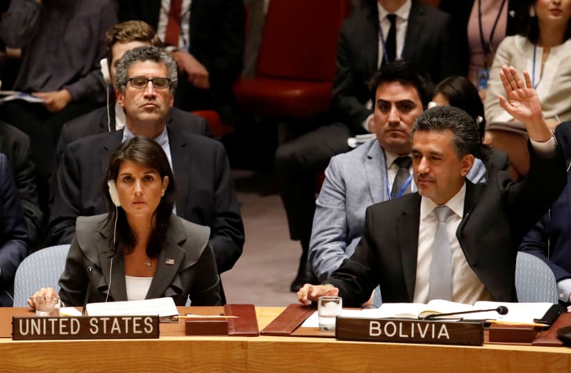 U.S. Ambassador to the United Nations Nikki Haley vetoes a vote as Bolivian Ambassador Sacha Llorenty votes for a Arab-backed resolution for protection of Palestinian civilians (photo credit: SHANNON STAPLETON / REUTERS)