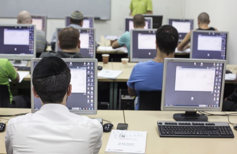 An ultra-Orthodox Jewish man attends a computer course at a technical college in Jerusalem October 16, 2013. (photo credit: REUTERS/BAZ RATNER)