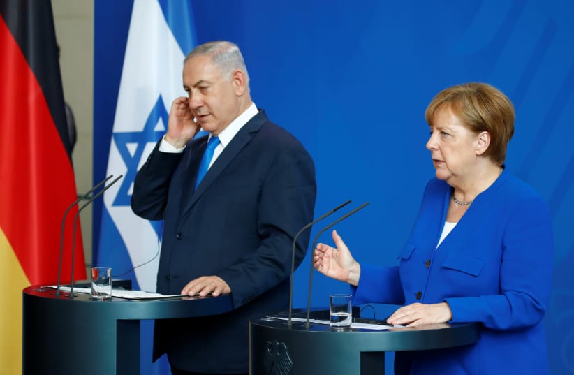 German Chancellor Angela Merkel gestures during a news conference with Israeli Prime Minister Benjamin Netanyahu in Berlin (photo credit: AXEL SCHMIDT/REUTERS)