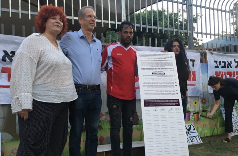 demonstrators hold a petition for rehabilitation of South Tel Aviv (photo credit: Courtesy)
