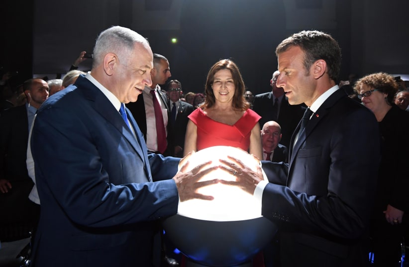 Prime Minister Benjamin Netanyahu with French President Emmanuel Macron at the Paris Grand Palais (photo credit: GPO PHOTO DEPARTMENT)