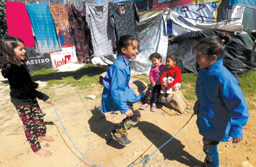 SYRIAN REFUGEE children play at a tented settlement in the town of Qab Elias, in Lebanon’s Bekaa Valley, on March 13 (photo credit: REUTERS)
