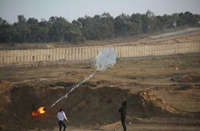 Palestinians in Gaza prepare a kite amid protests at the border fence, June 8, 2018. (photo credit: IDF SPOKESMAN’S UNIT)