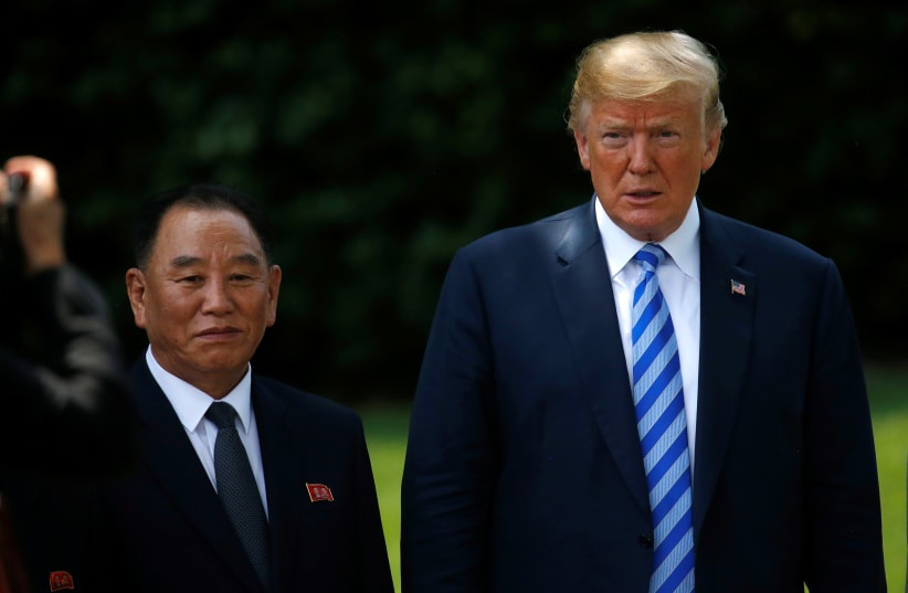 North Korea's envoy Kim Yong Chol poses with US President Donald Trump for a photo as he departs after a meeting at the White House in Washington, US, June 1, 2018 (photo credit: REUTERS/LEAH MILLIS)