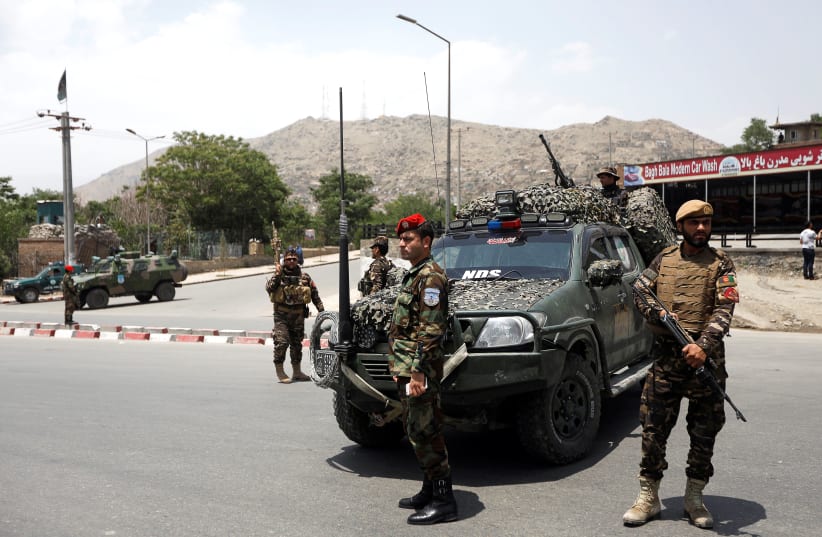 Afghan security forces keep watch at the site of a suicide attack in Kabul, Afghanistan June 4, 2018. (photo credit: OMAR SCOBHANI / REUTERS)