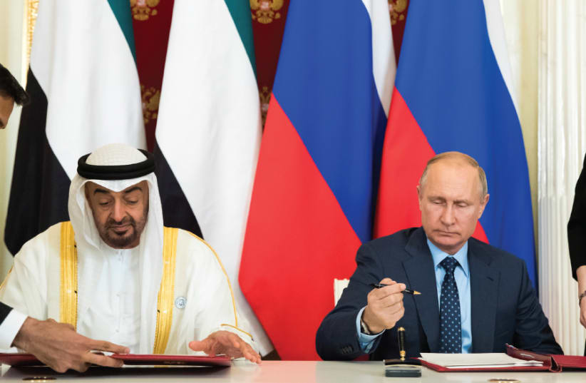 RUSSIAN PRESIDENT Vladimir Putin (seated, right) and Abu Dhabi’s Crown Prince Sheikh Mohammed bin Zayed al- Nahyan (seated, left) attend a signing ceremony following talks at the Kremlin in Moscow on June 1, 2018 (photo credit: REUTERS)