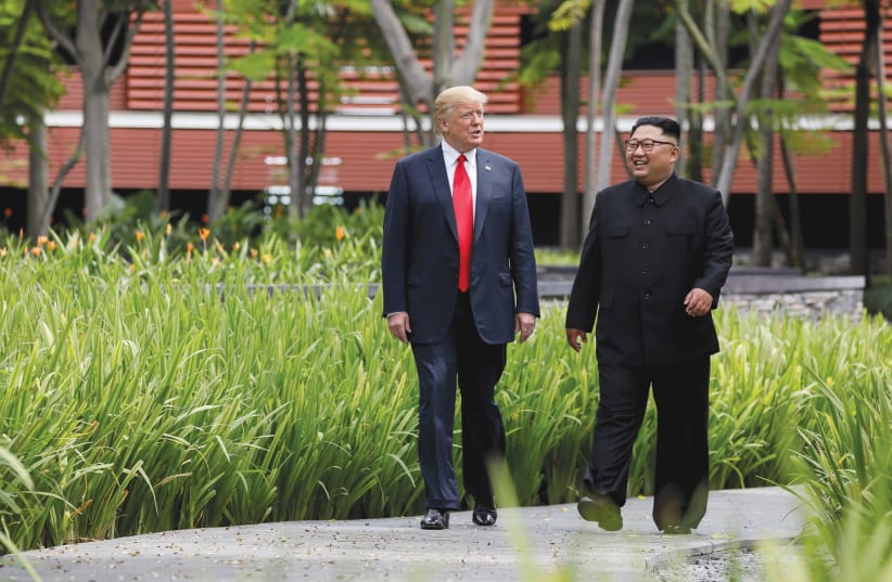 U.S. PRESIDENT Donald Trump and North Korea’s leader Kim Jong Un walk together in Sentosa, Singapore in June, 2018 (photo credit: JONATHAN ERNST / REUTERS)