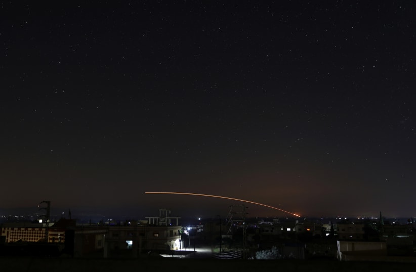 Missile fire is seen over Daraa, Syria (photo credit: ALAA AL-FAKIR / REUTERS)