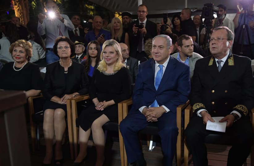 Prime Minister Benjamin Netanyahu and his wife, Sara, attend Russia Day celebrations in Jerusalem, June 14th, 2018 (photo credit: AMOS BEN-GERSHOM/GPO)