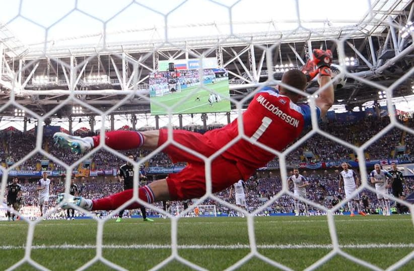 Iceland's Hannes Por Halldorsson saves a penalty from Argentina's Lionel Messi on June 16th, 2018 (photo credit: REUTERS/CARL RECINE)
