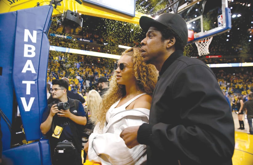 BEYONCE AND Jay-Z  attend the 2018 NBA Playoffs in April. (photo credit: CARY EDMONSON/REUTERS)