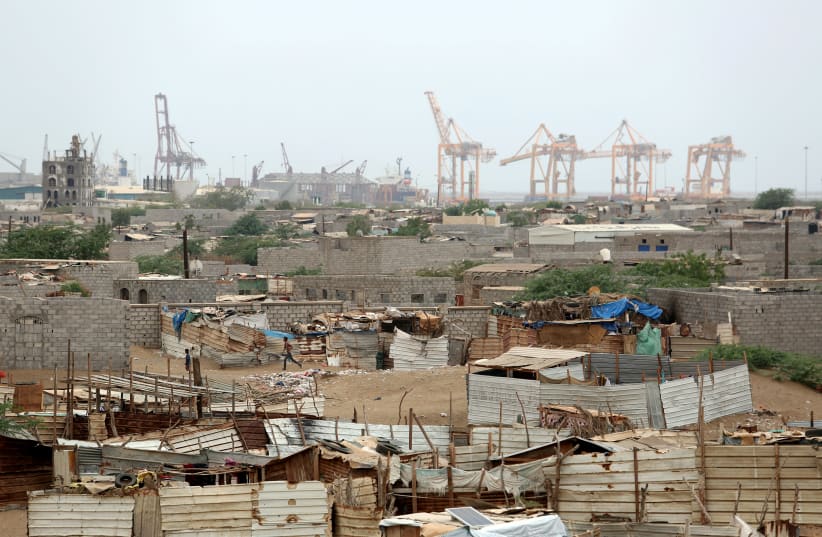 Hodeidah port's cranes are pictured from a nearby shantytown in Hodeidah, Yemen (photo credit: REUTERS/ABDULJABBAR ZEYAD)