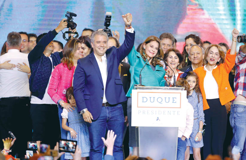President Ivan Duque and Vice President Marta Lucia Ramirez celebrate after they win the presidential election in Bogota on Sunday (photo credit: ANDRES STAPFF/REUTERS)