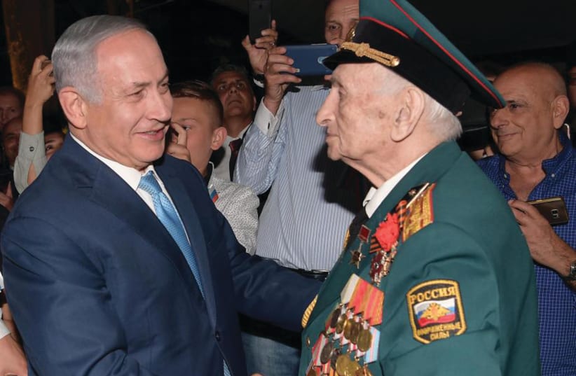 PRIME MINISTER Benjamin Netanyahu greets the bemedaled veteran of the Red Army Emil Zigel on Victory Day.  (photo credit: AMOS BEN-GERSHOM/GPO)