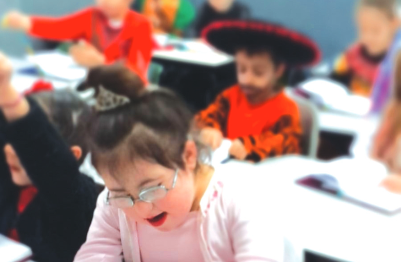 HALLEL, EIGHT, who has Down syndrome and is part of the inclusive education system, reads a ‘pasuk’ on Purim (photo credit: COURTESY HALLEL'S PARENTS)
