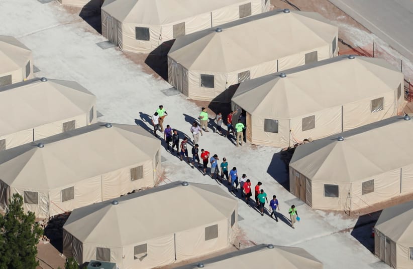 Immigrant children, many of whom have been separated from their parents under a new "zero tolerance" policy by the Trump administration, are being housed in tents next to the Mexican border in Tornillo, Texas, U.S. June 18, 2018. (photo credit: REUTERS/MIKE BLAKE)