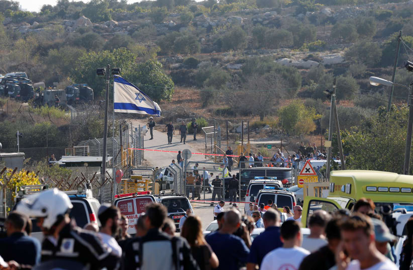 Israeli security at the scene where a Palestinian terrorist opened fire on Israelis at the Har Adar settlement, outside of Jerusalem, Sept. 26, 2017. (photo credit: AMMAR AWAD / REUTERS)