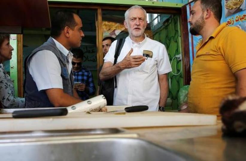 Britain's opposition leader Jeremy Corbyn during his visit to Al Zaatari refugee camp, in the Jordanian city of Mafraq, near the border with Syria, June 22, 2018 (photo credit: MUHAMMAD HAMED / REUTERS)