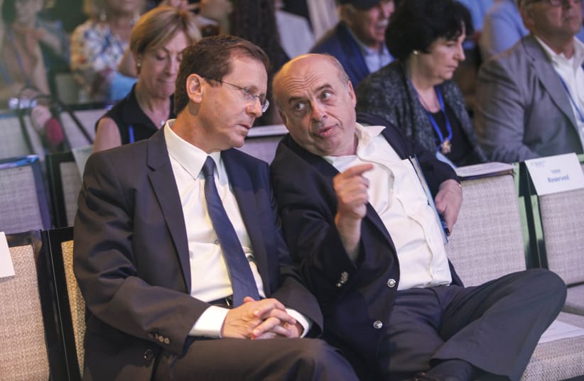 Outgoing Jewish Agency Chairman Natan Sharansky and Chairman-elect MK Isaac Herzog share a moment following Herzog’s election at the Jewish Agency Board of Governors’ meetings in Jerusalem, June 24, 2018.  (photo credit: JEWISH AGENCY)